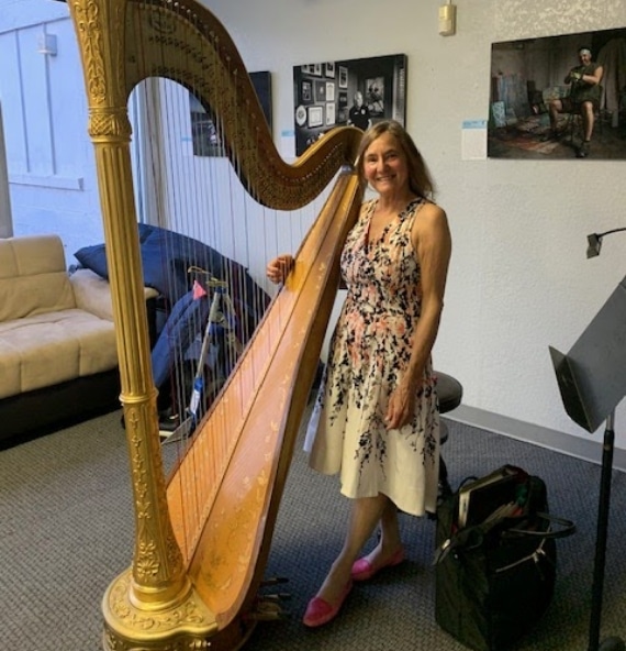 Roseanne holding her harp