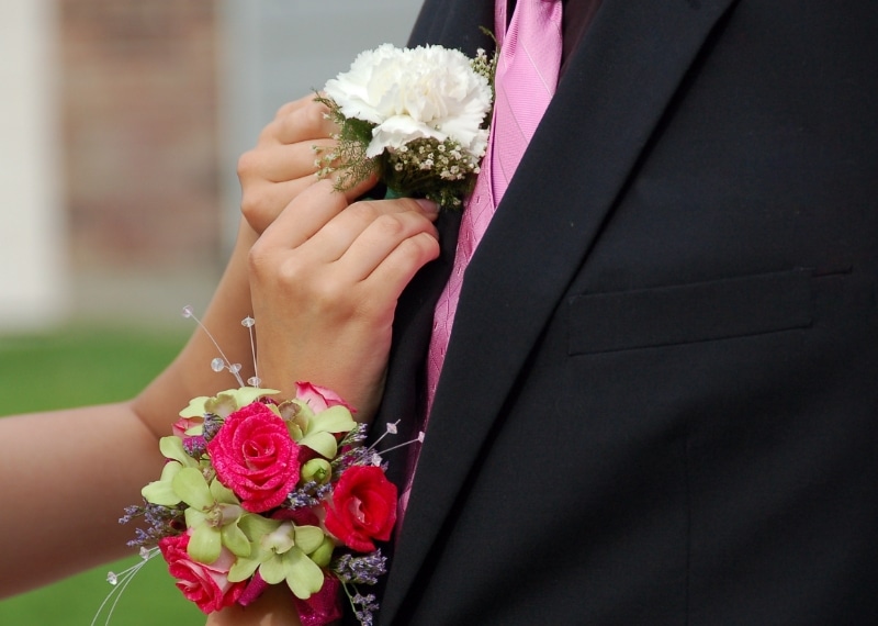 pinning a flower on a tuxedo